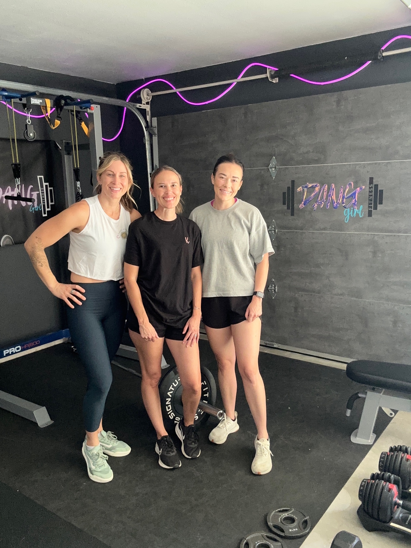 Three women smiling in the Dang Girl gym